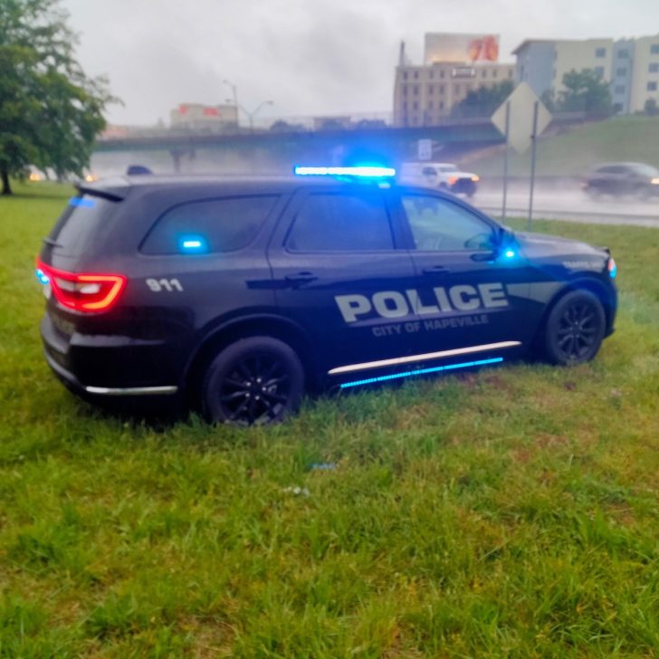 Hapeville police cruiser positioned in a grassy lot near the street.