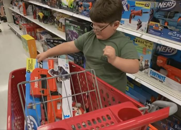 Gabe Lyles pick a Nerf gun during his shopping spree