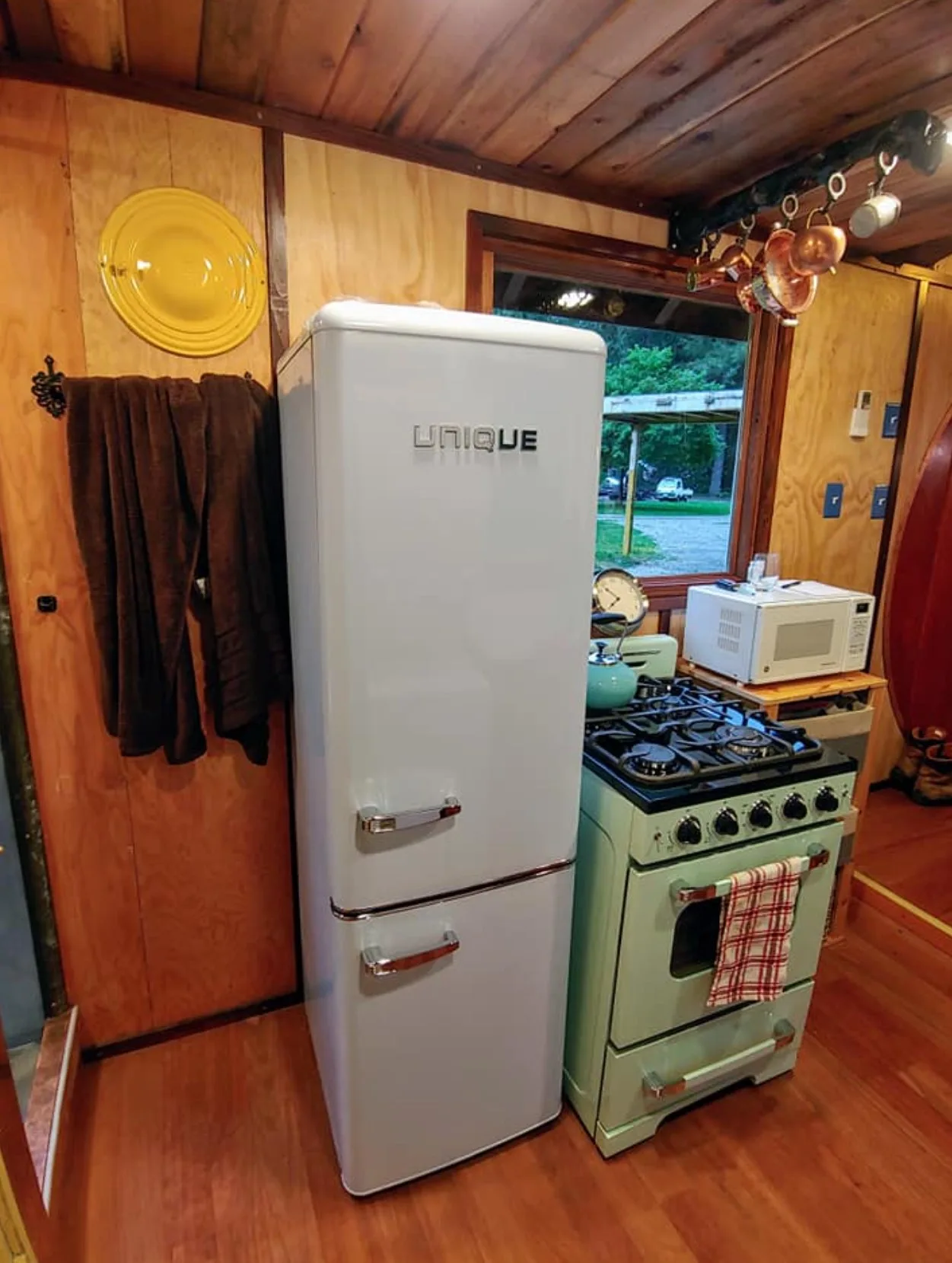 Two-door fride at the tiny house, sitting next to the stove.