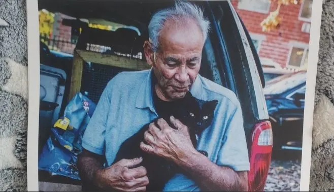 Willie Ortiz cuddles one of the stray cats he has been feeding for years