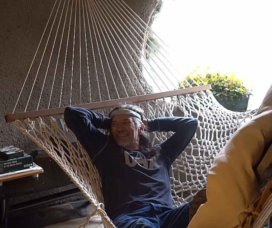 Al relaxing on his hammock inside his unique home.