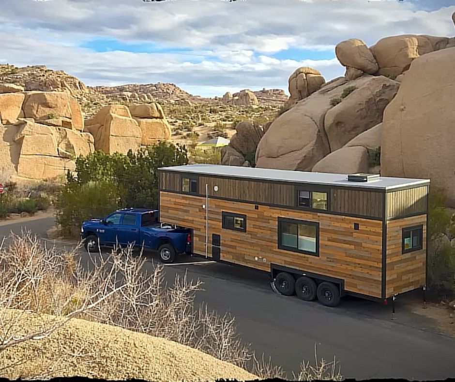 Kevin's tiny house on the road, connected to a blue pick up truck