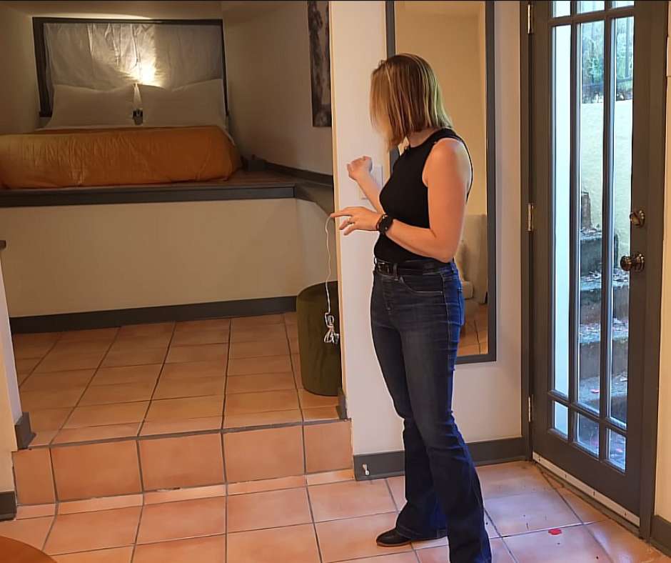 Emily showing the second bedroom with large bed at the house's lower level