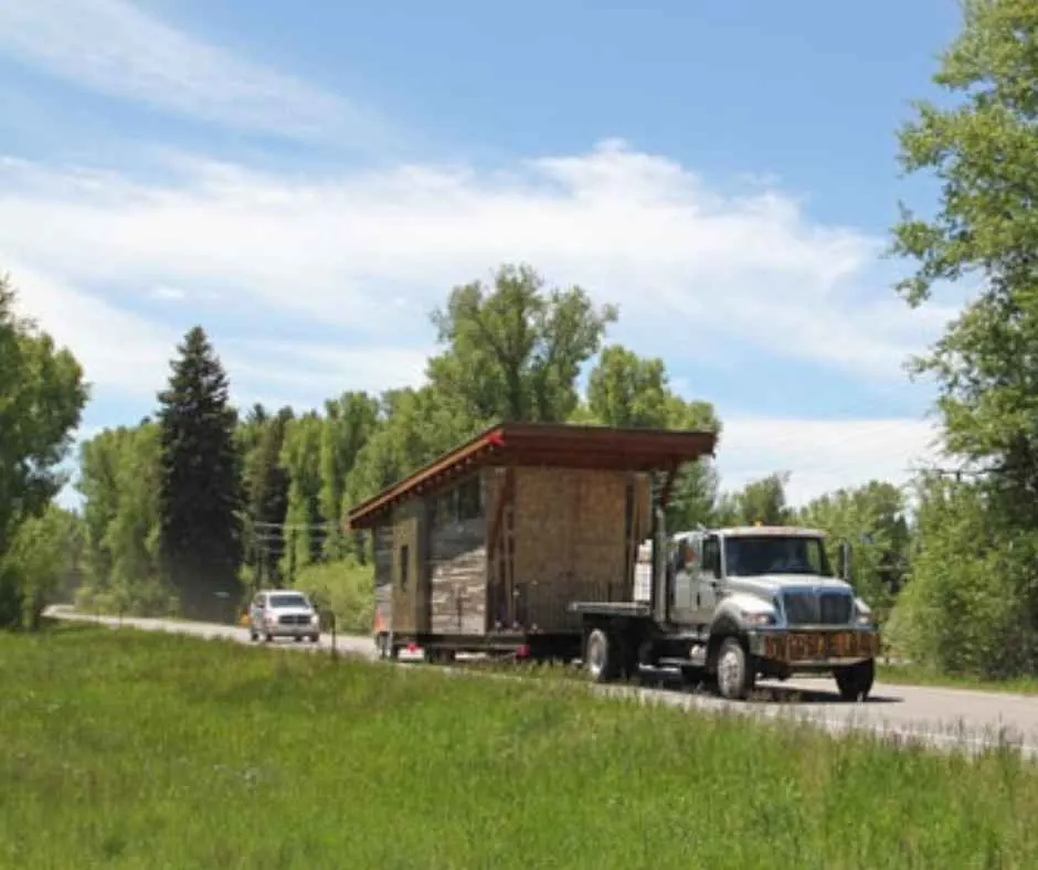 One of WheelHaus' prefab tiny homes being pulled by a truck.