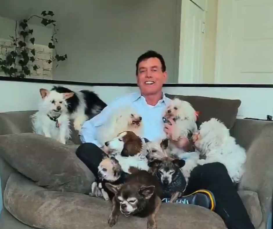 Steve with his dogs on the couch.