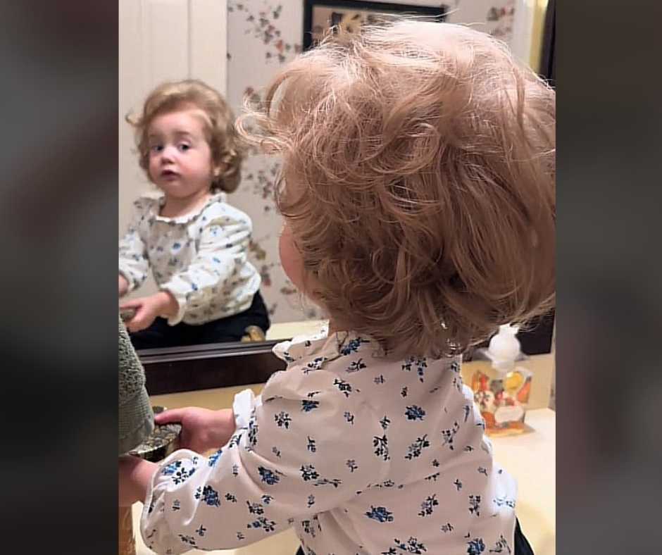 Evelyn Mae checking her self on the mirror