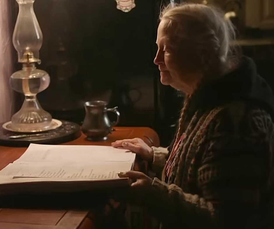 Carol reading her Dragon's Nest's journal