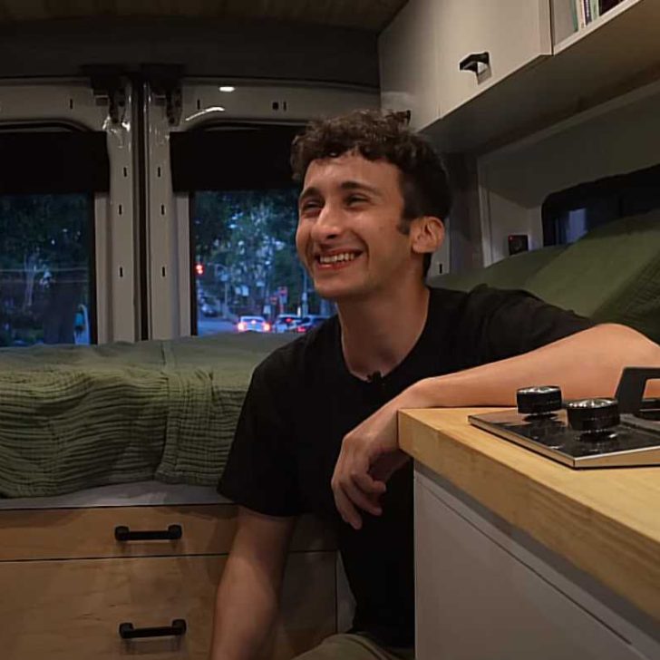 Ethan smiling, talks about his life inside a Ford Transit van conversion