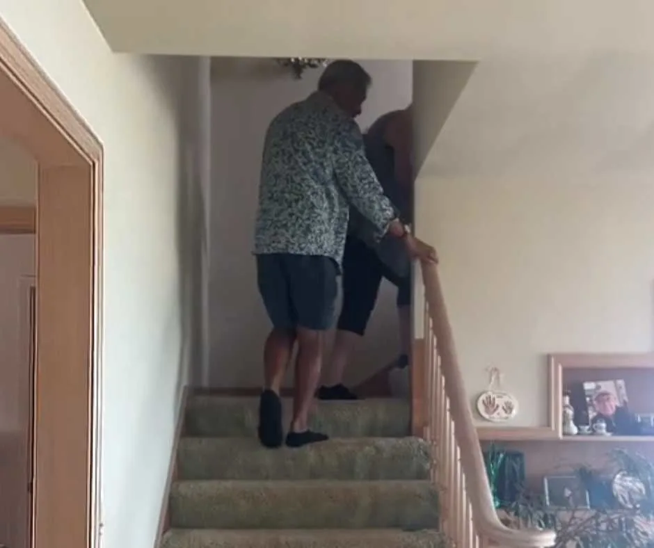 Megan's dad helps her mom climb on stairs