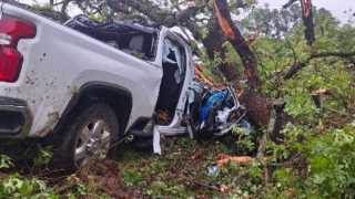 Baker Family's truck trapped in a fallen tree