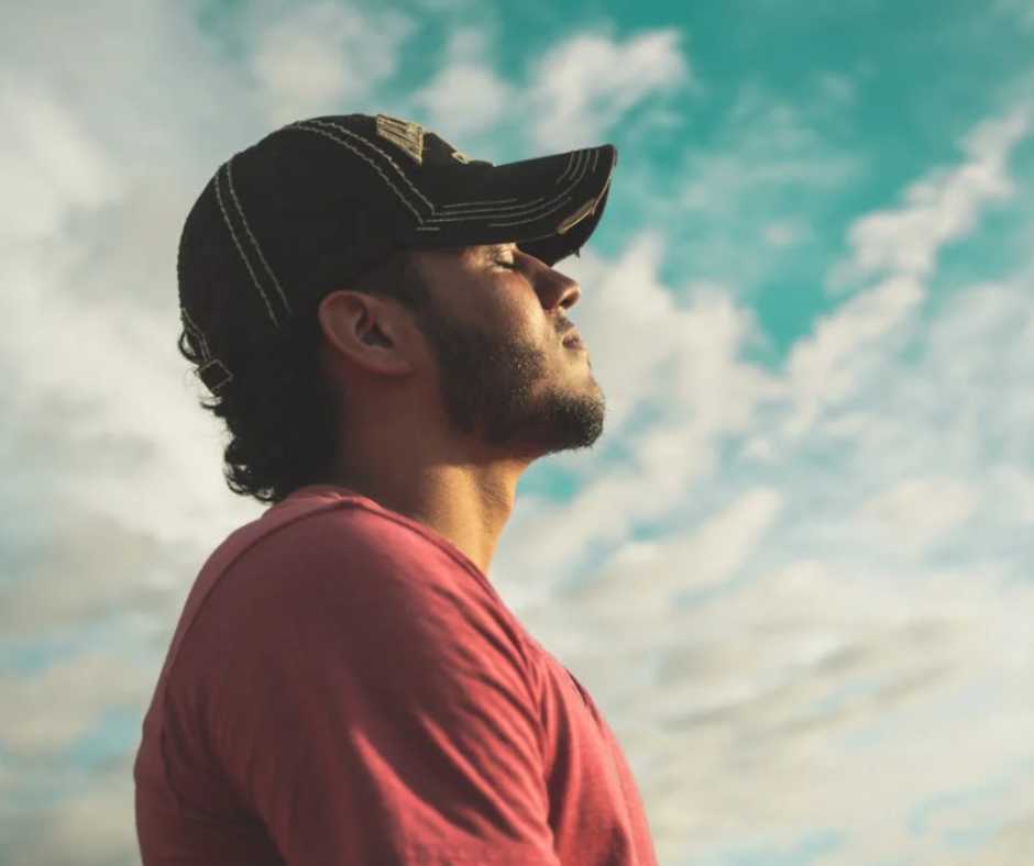 Man facing the sky with eyes closed
