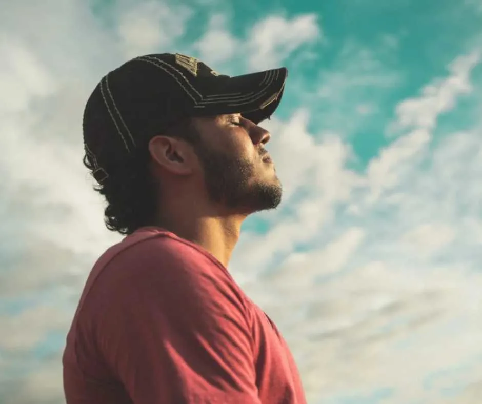 Man facing the sky with eyes closed