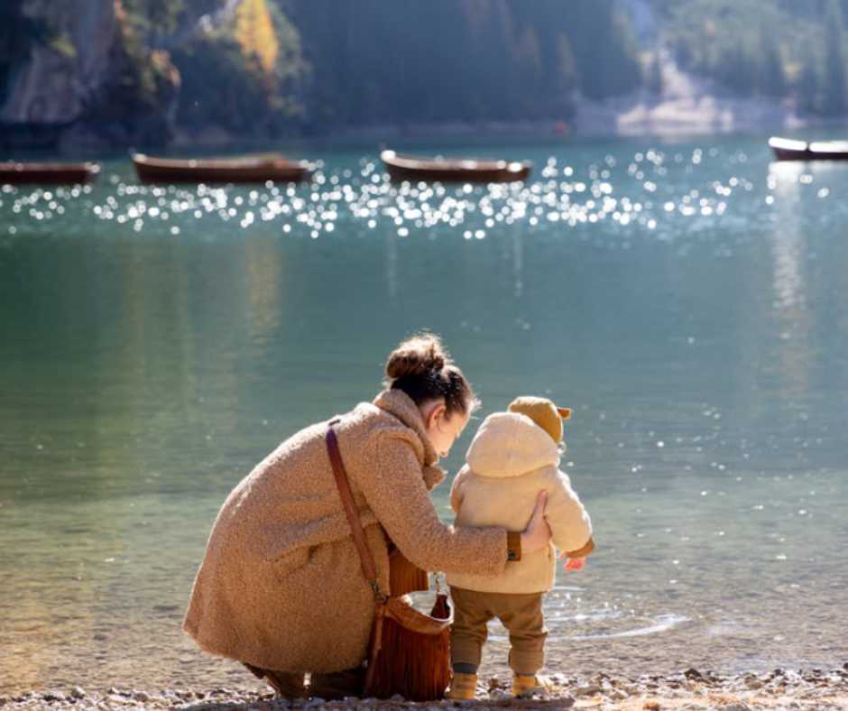 Mother and child exploring the lakeshore