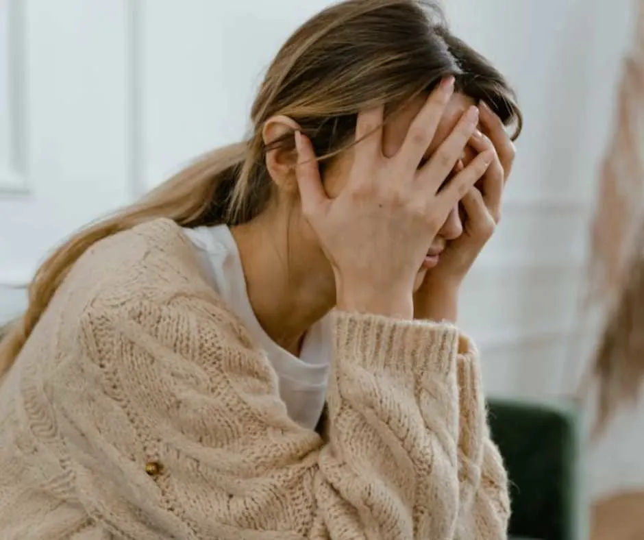 Woman covering her face with hands
