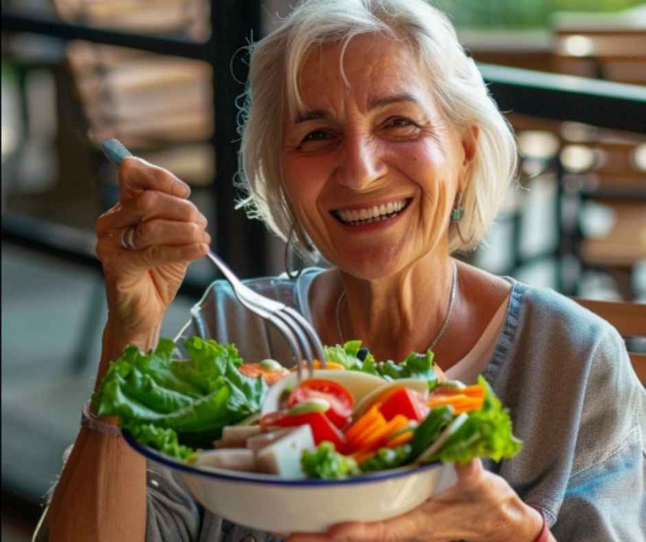 Elderly woman holding a bowl of vegetable salad