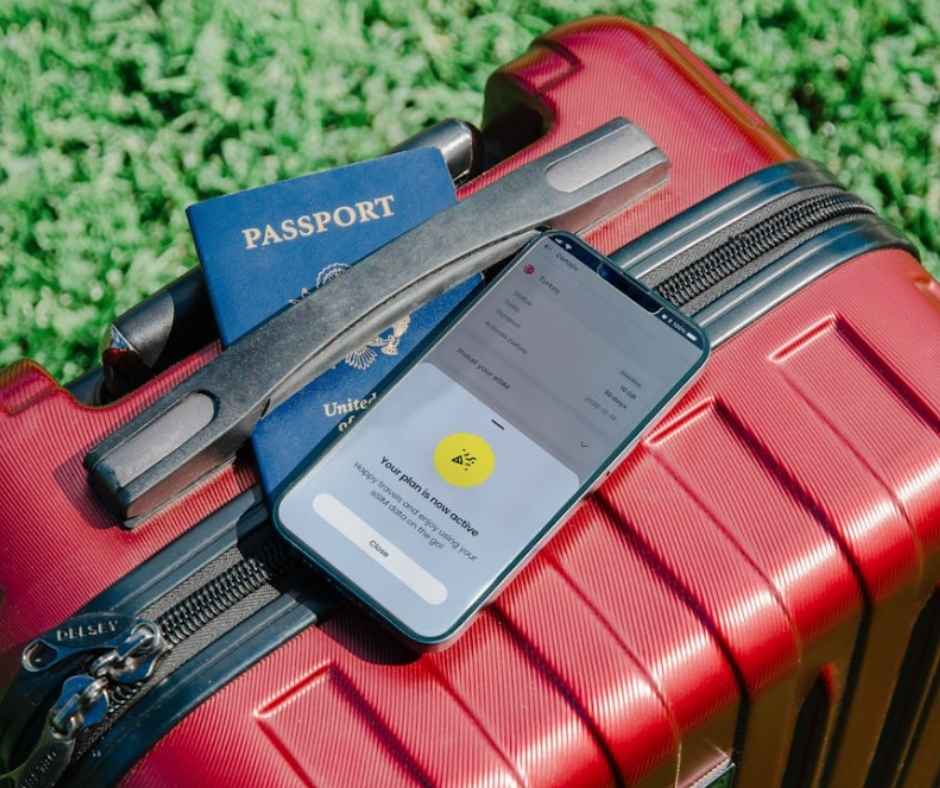 A luggage, a passport, and a smartphone